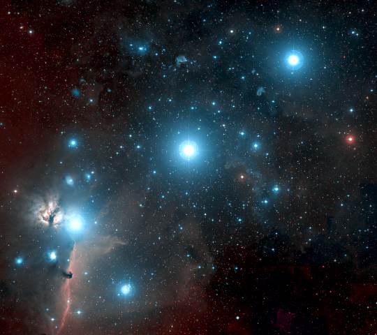 The stars of Orion's belt shrouded in faint nebulosity